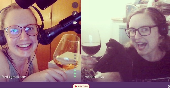 Image: screenshot of two young white women on a video call. Both have a glass wine in their hand and they're smiling as they attempt a virtual 'cheers'.