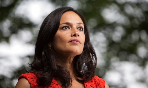 Image description: photograph of Tishani Doshi, a middle aged woman with dark wavy hair wearing a red dress.