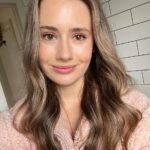 Image description: photograph of a young woman with long hair smiling